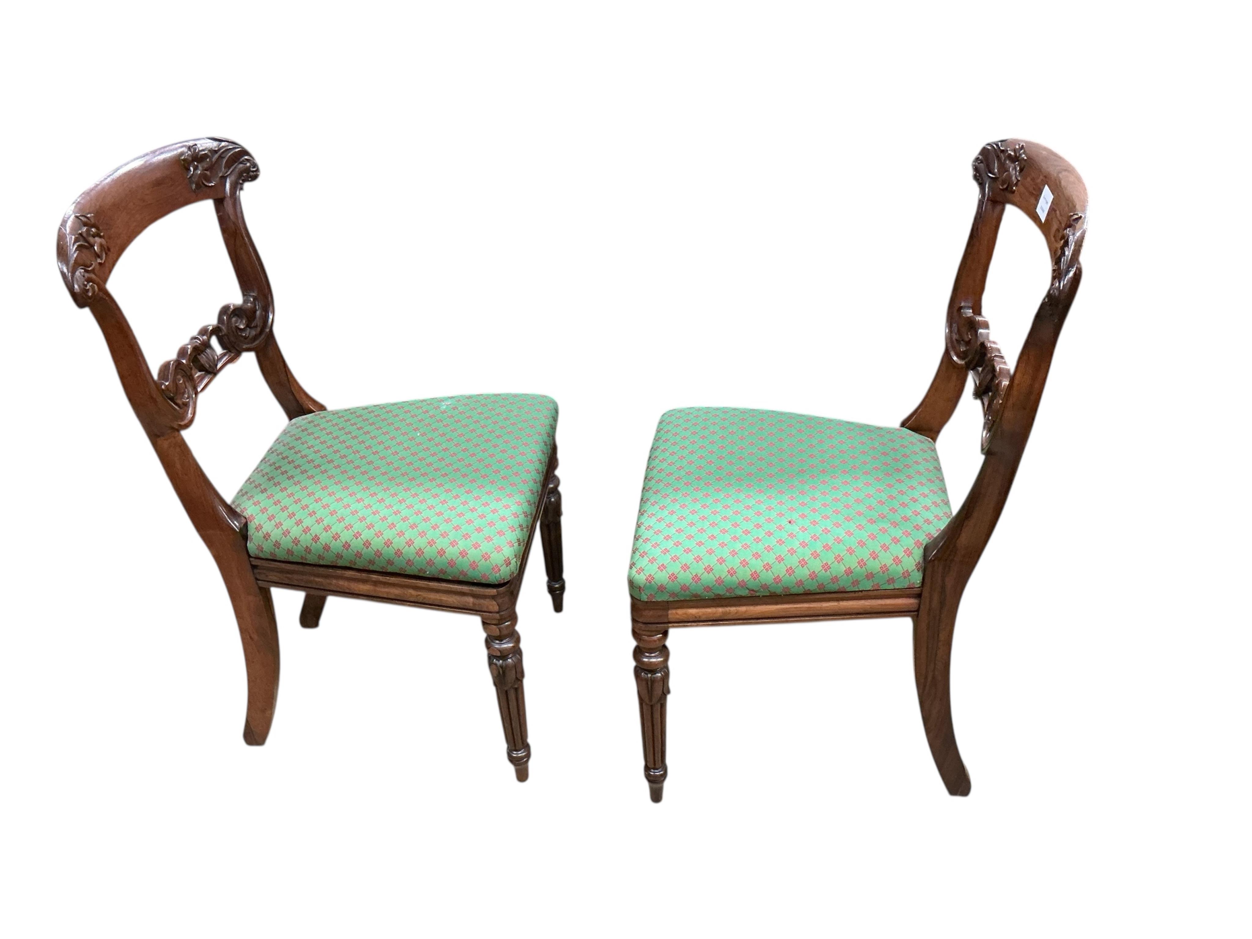 A pair of William IV rosewood dining chairs, with foliate carved decoration to the back supports, width 49cm, height 86cm